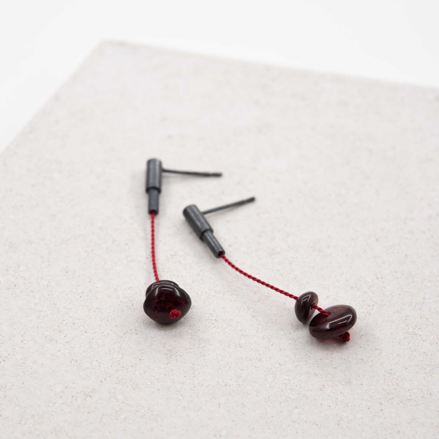 Garnet stone dangle earrings in oxidized silver with red silk cord