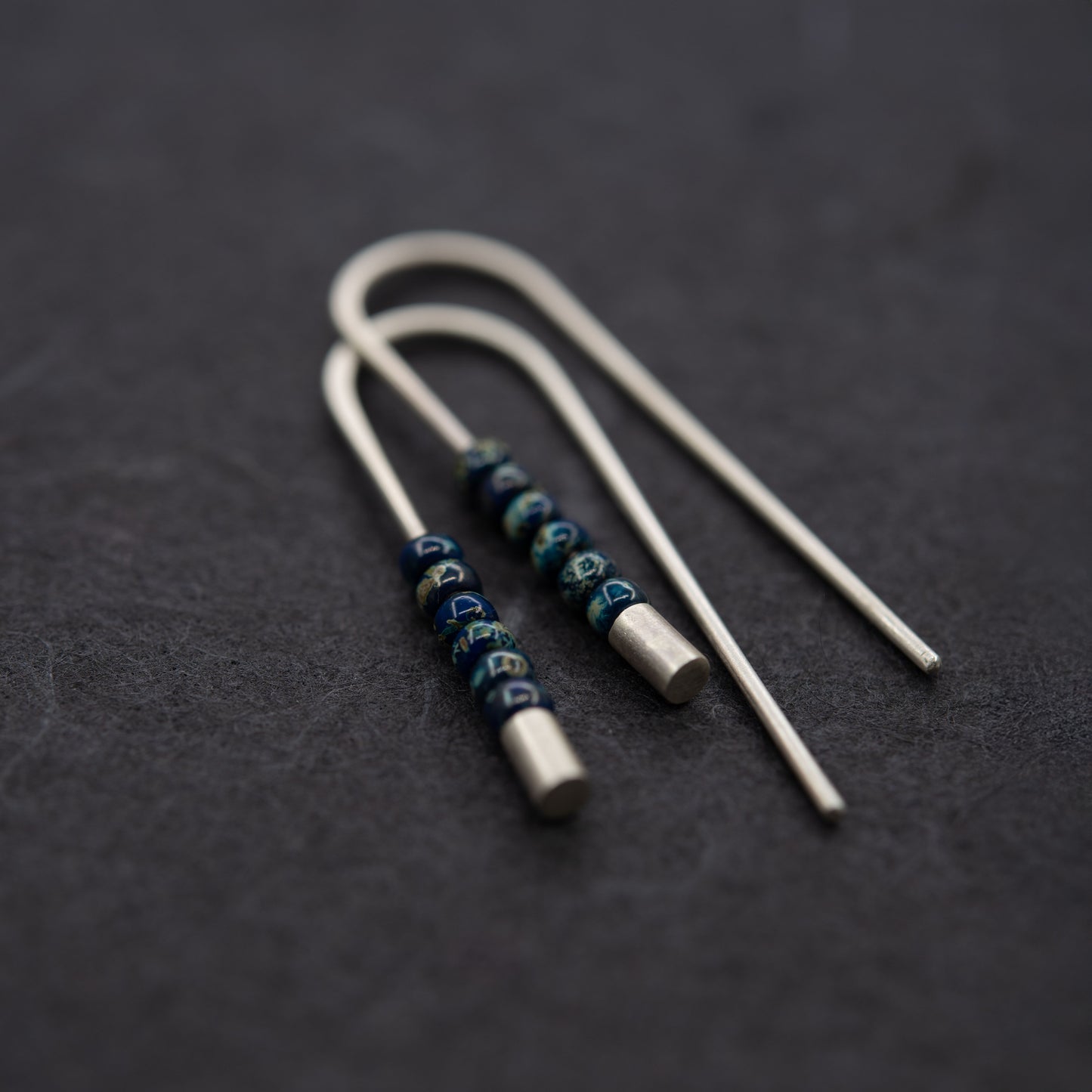 Long handmade silver threader earrings with matte surface and Miyuki seed beads, minimal modern style.