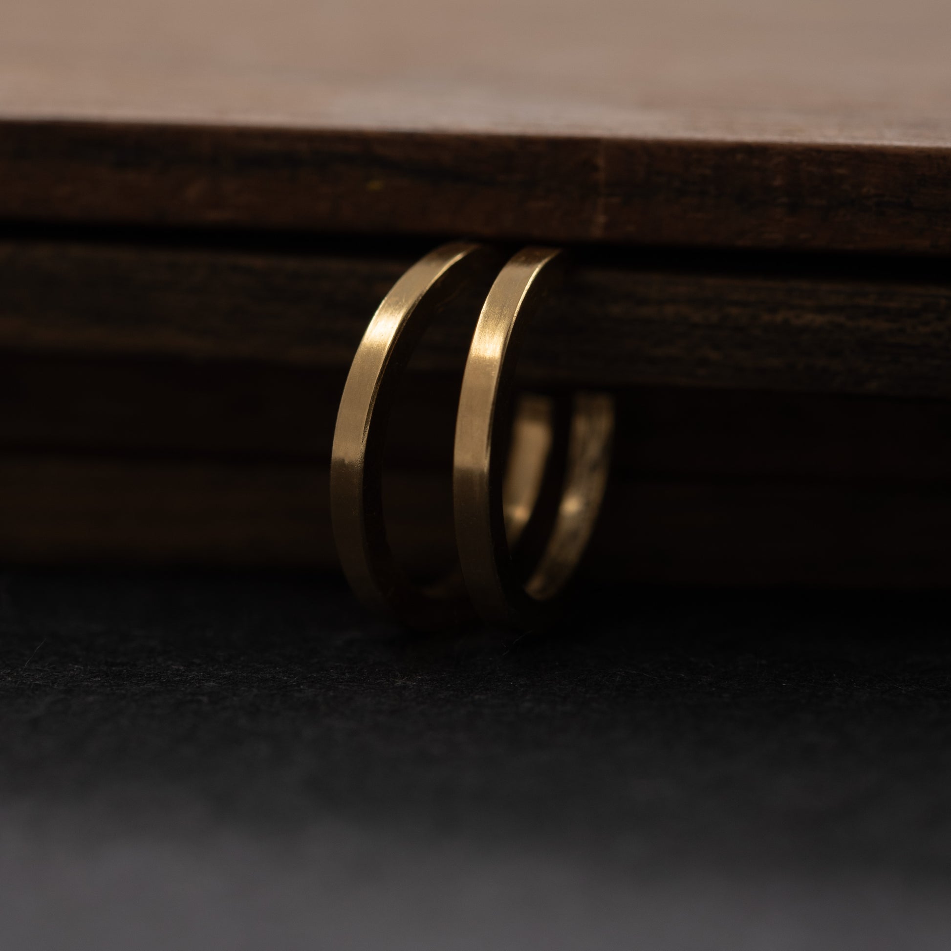 Small gold vermeil hoop earring worn by a woman with brown hair, subtle handmade jewelry made in Paris.