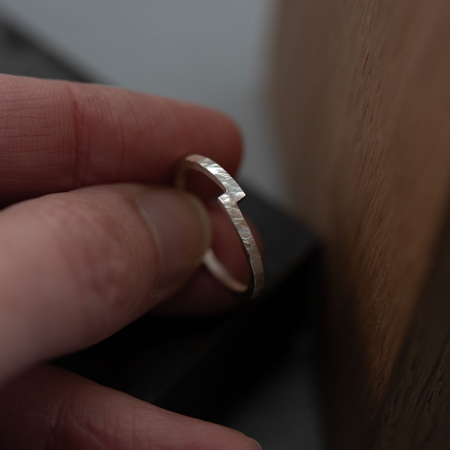 Handcrafted sterling silver unity ring with a symbolic design of two merging ends, representing connection and harmony. Made from a 1.5mm square wire with a hammered texture and a unique notch detail, this minimalist ring is perfect as a wedding band, engagement ring, or meaningful everyday accessory. A modern, timeless piece, shaped and polished by hand for a unique, personal touch.