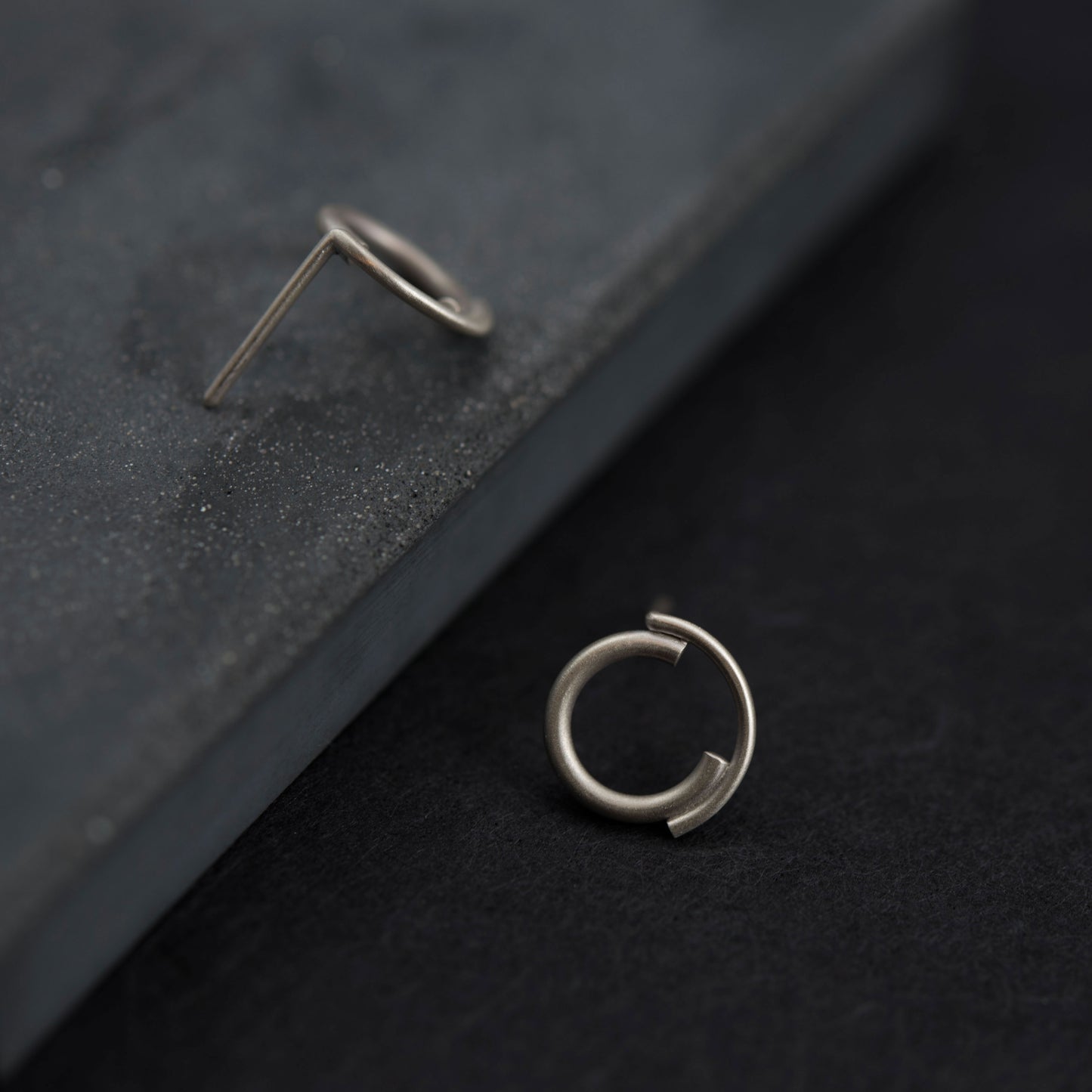 close up os a 12 millimeters concentric circle studs in a dark blue background