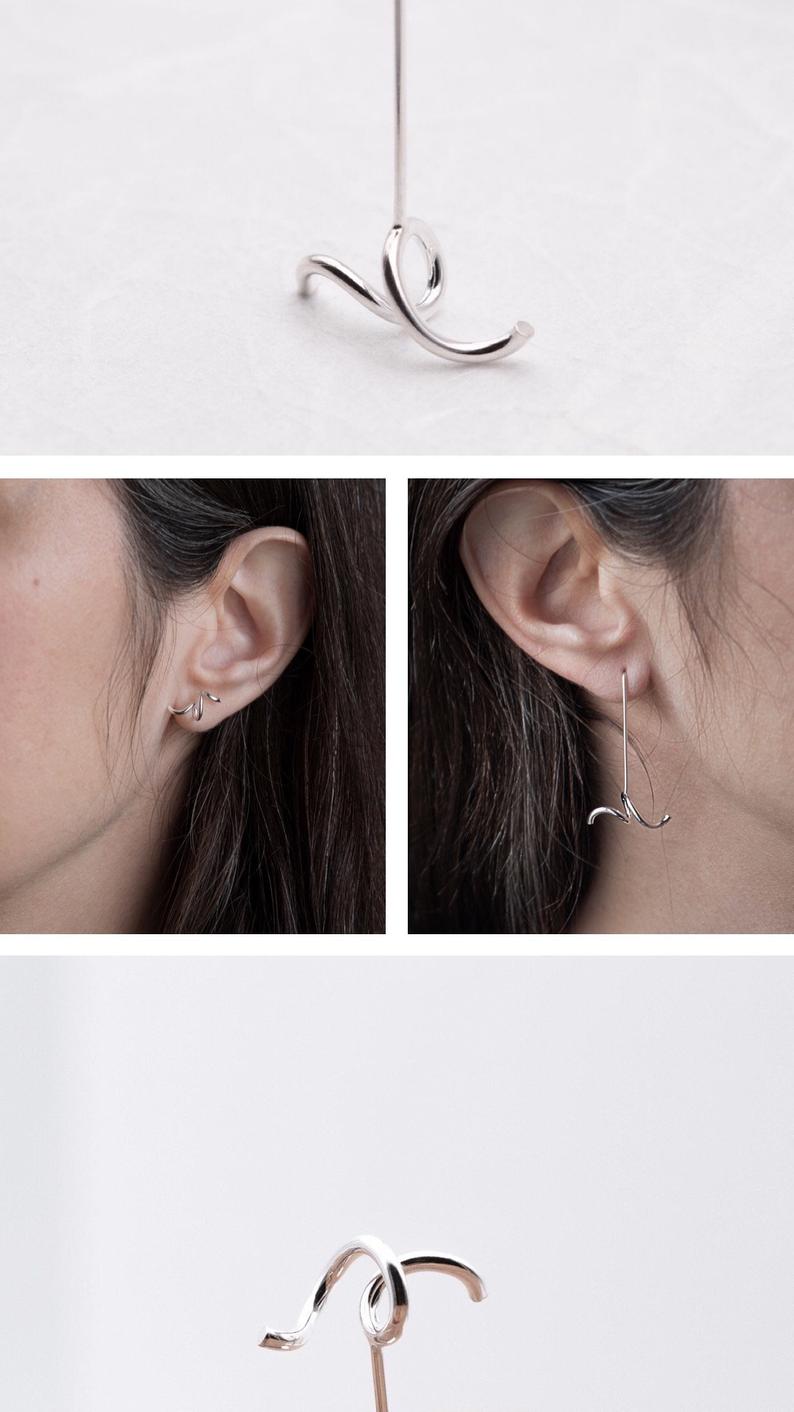 This pair of mismatched earrings are designed to create an asymmetric finishing touch.