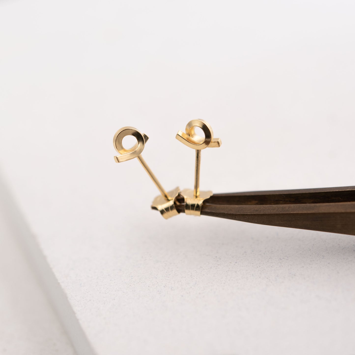 Tiny loop studs earrings of crafted by hand from a 1,5 mm square wire of sterling silver and then shiny finished and gold plated. Length of 5 Millimeters and width of 7 Millimeters