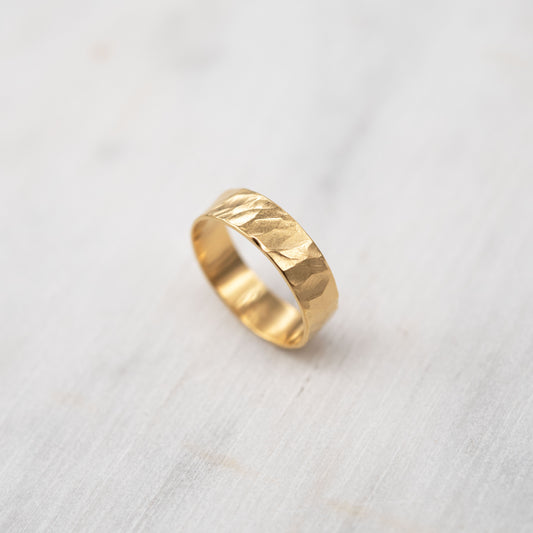 Hand-textured gold vermeil ring with a hammered finish, made from sterling silver and coated in 24k yellow gold. The ring has an organic, artisanal texture and a minimalist, elegant design. Set against a soft, neutral background.