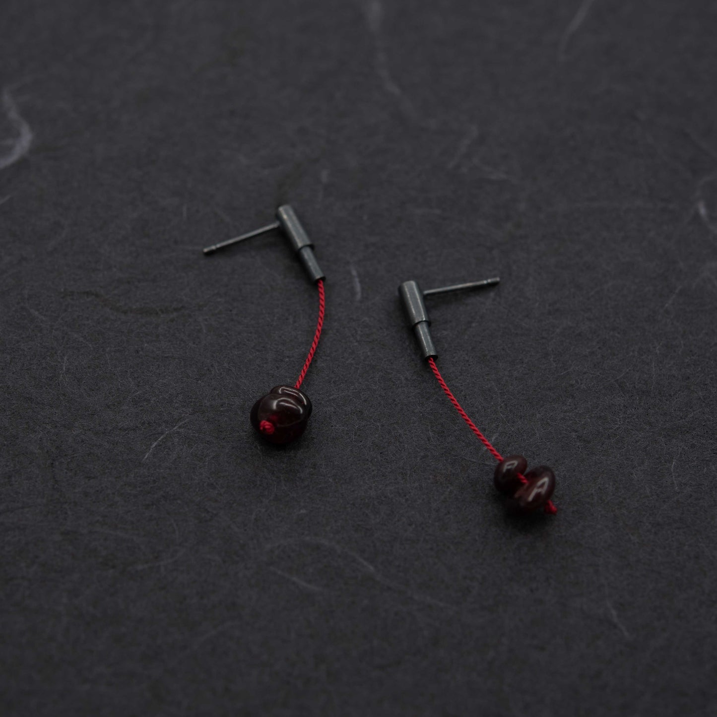 Garnet stone dangle earrings in oxidized silver with red silk cord