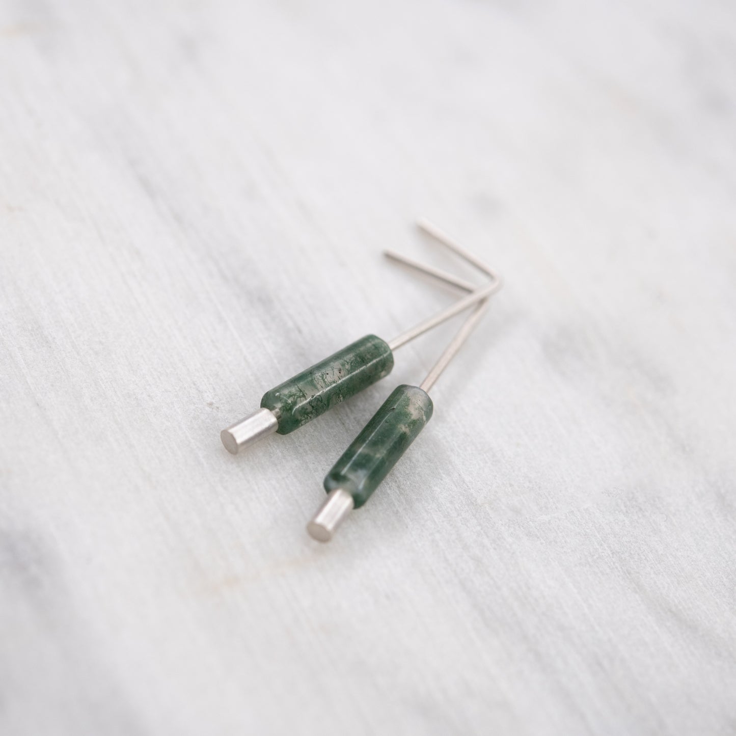 Contemporary sterling silver earrings with natural green moss agate details