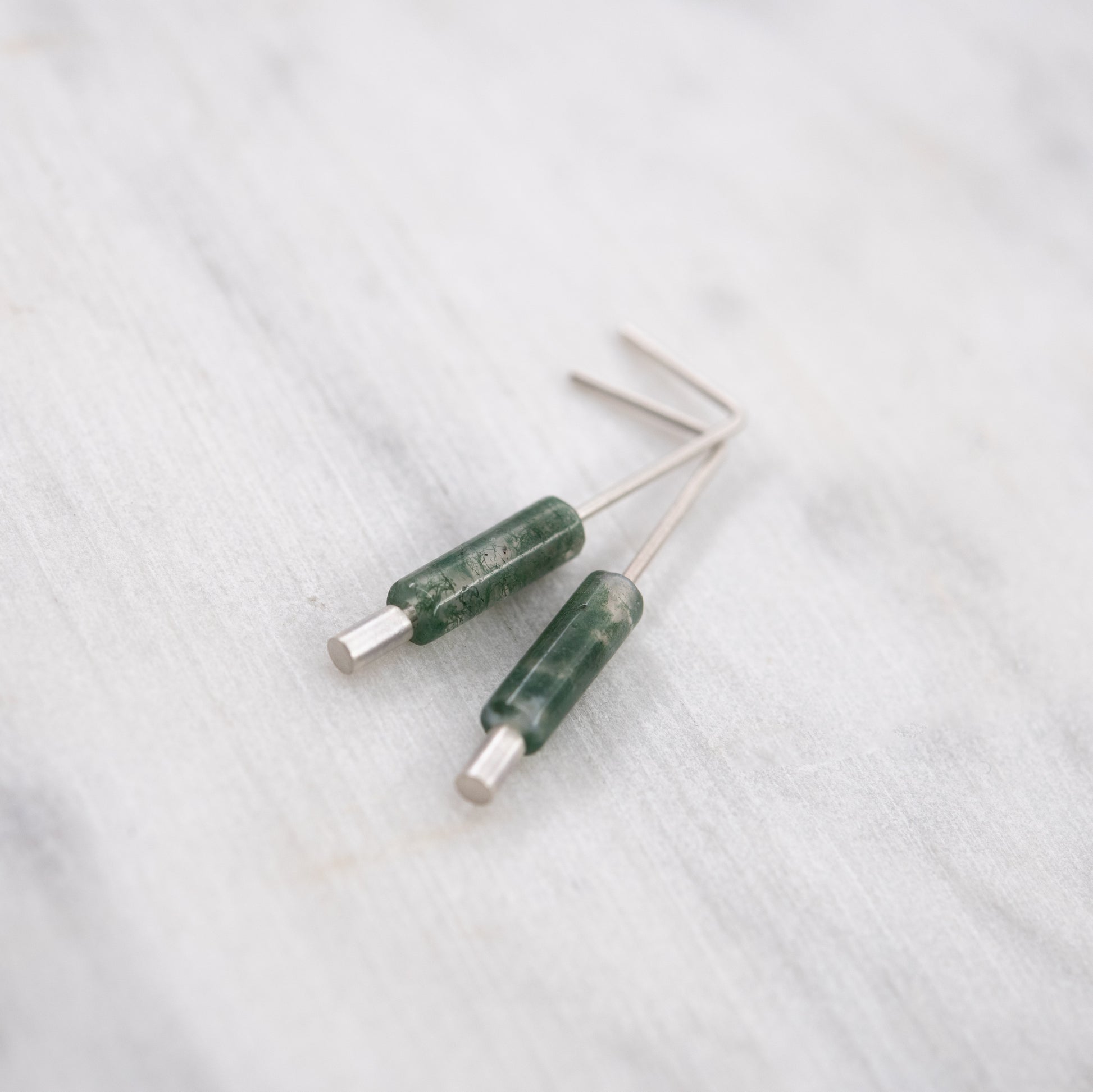 Contemporary sterling silver earrings with natural green moss agate details