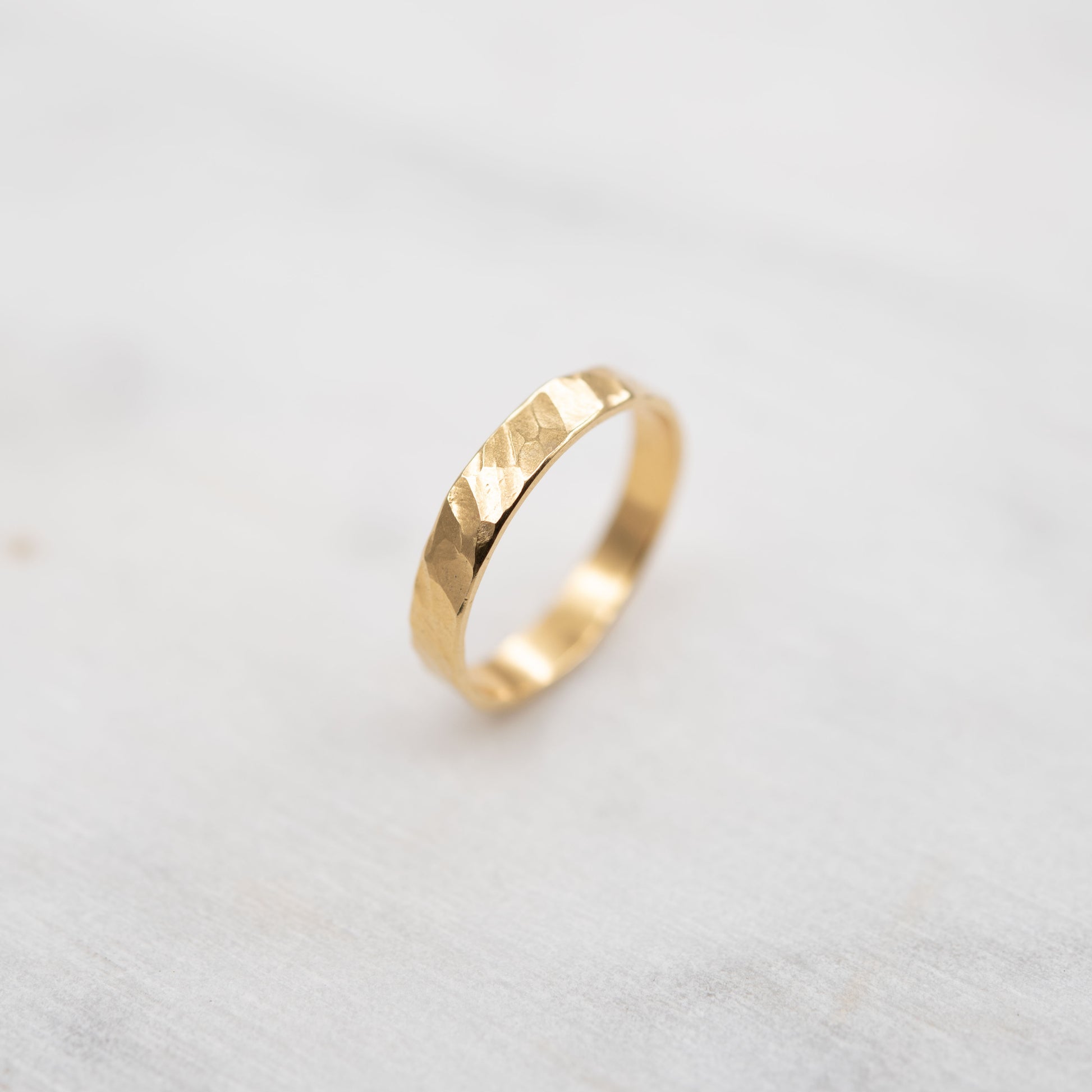 Close-up of handmade hammered gold vermeil band, poetic and modern artisan jewel made in Paris