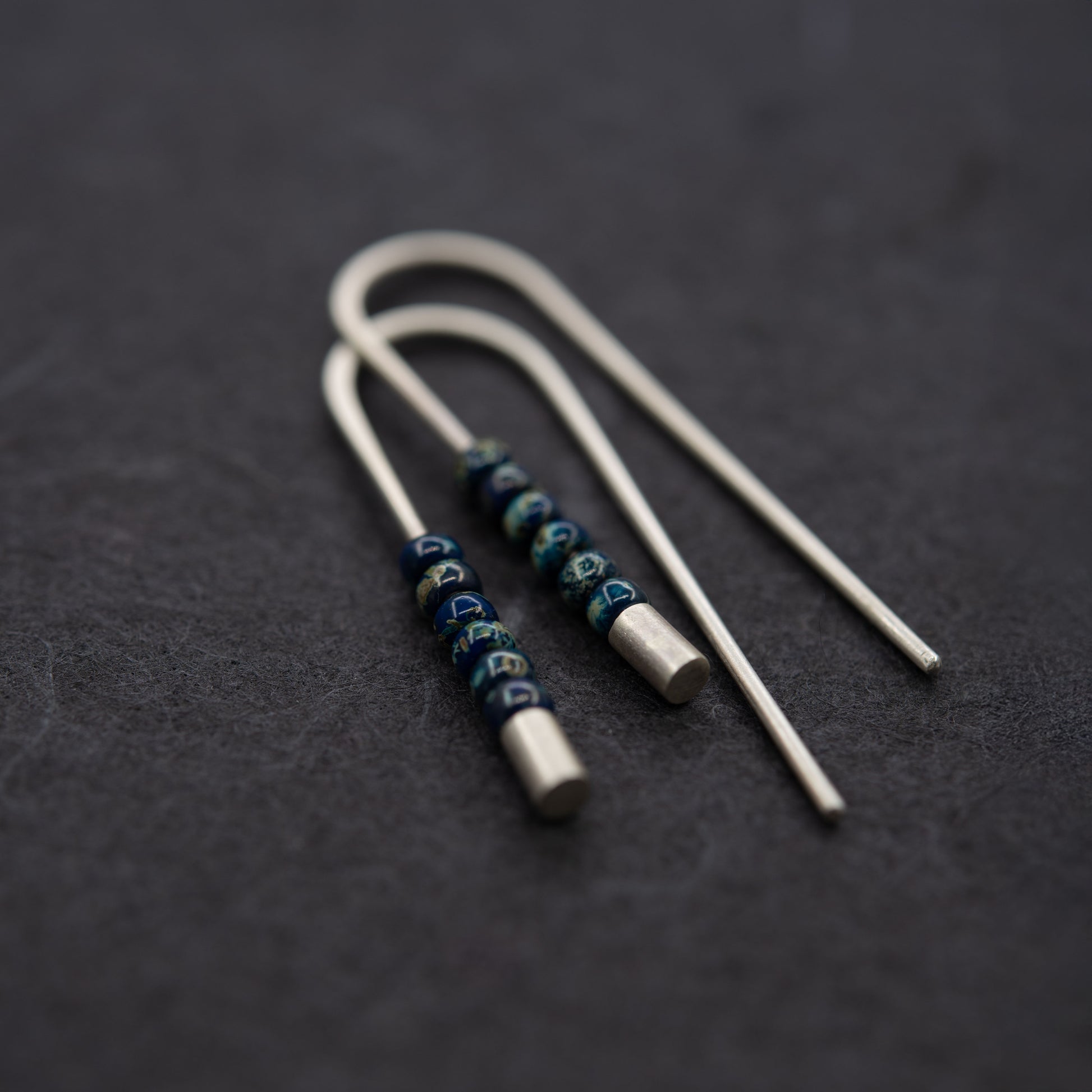 Long handmade silver threader earrings with matte surface and Miyuki seed beads, minimal modern style.