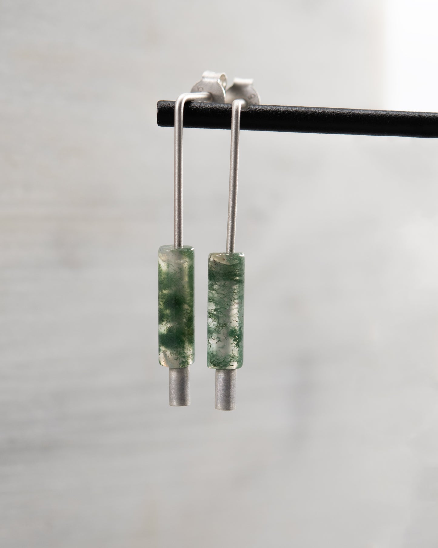 Detail view of handmade sterling silver and moss agate earrings