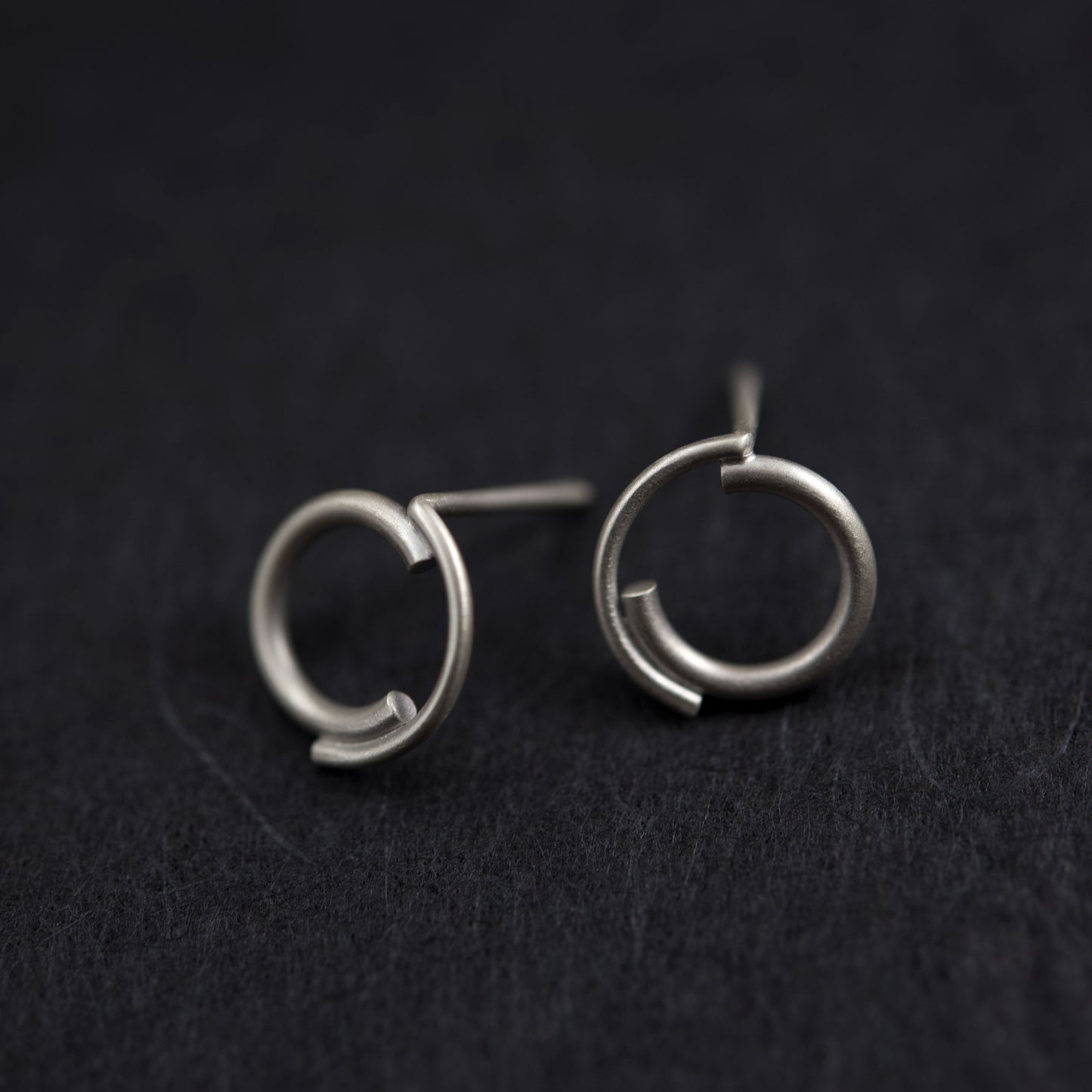 A close up of a 12 millimeters diameter concentric circle studs matte finished