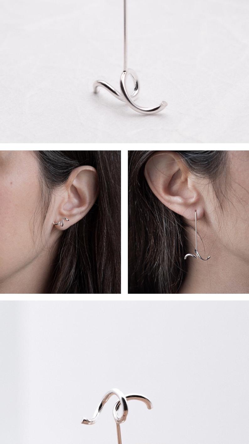 This pair of mismatched earrings are designed to create an asymmetric finishing touch. 