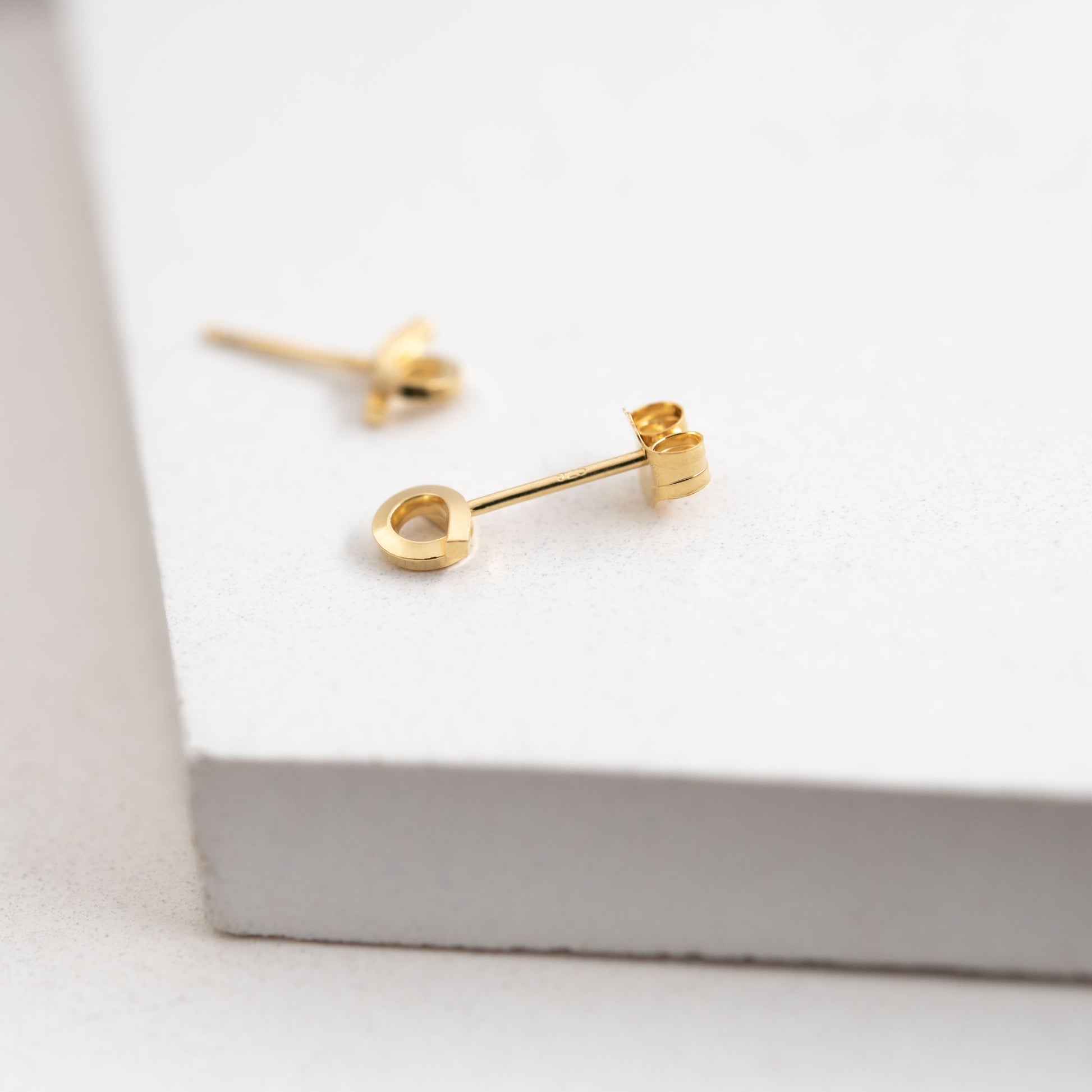 Tiny loop studs earrings crafted by hand from a 1,5 mm square wire of sterling silver and then shiny finished and gold plated. Length: 5 Millimeters; Width: 7 Millimeters