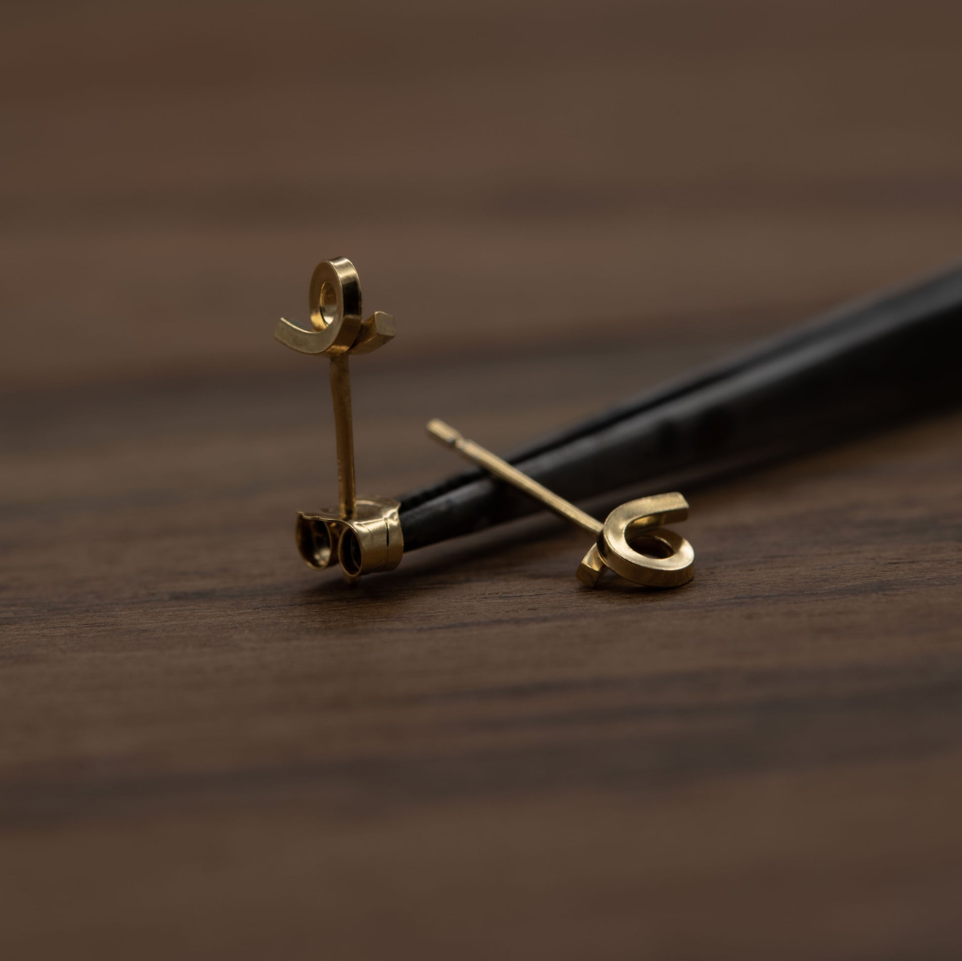 Tiny loop studs earrings of crafted by hand from a 1,5 mm square wire of sterling silver and then shiny finished and gold plated. Length: 5 Millimeters; Width: 7 Millimeters.