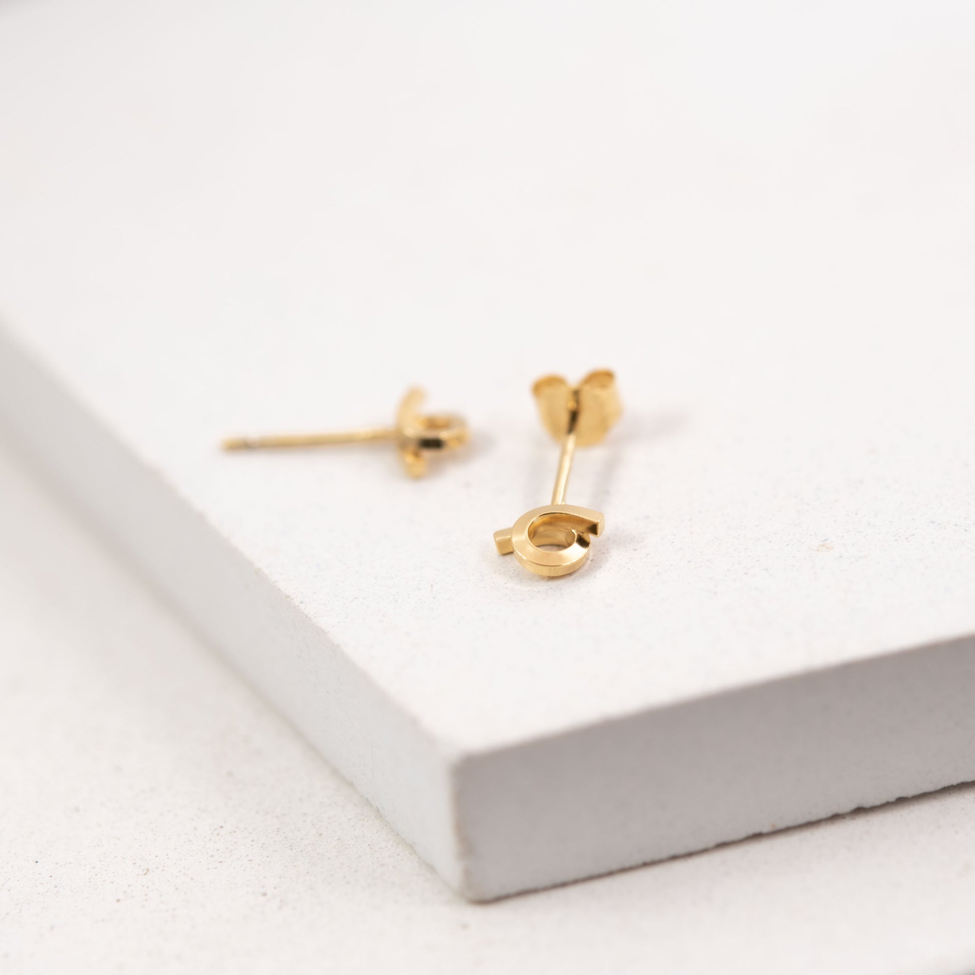Tiny loop studs earrings crafted by hand from a 1,5 mm square wire of sterling silver and then shiny finished and gold plated. Length: 5 Millimeters; Width: 7 Millimeters